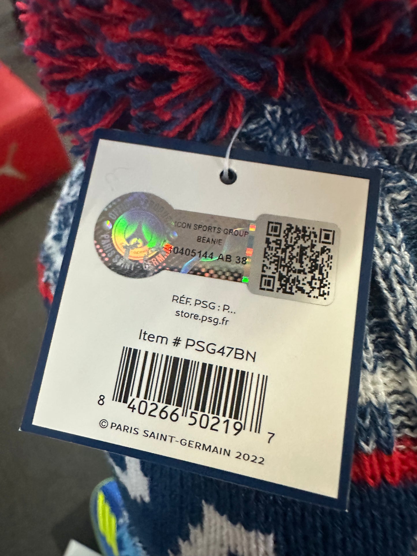 Product tag with a barcode and QR code on a sports-themed item.