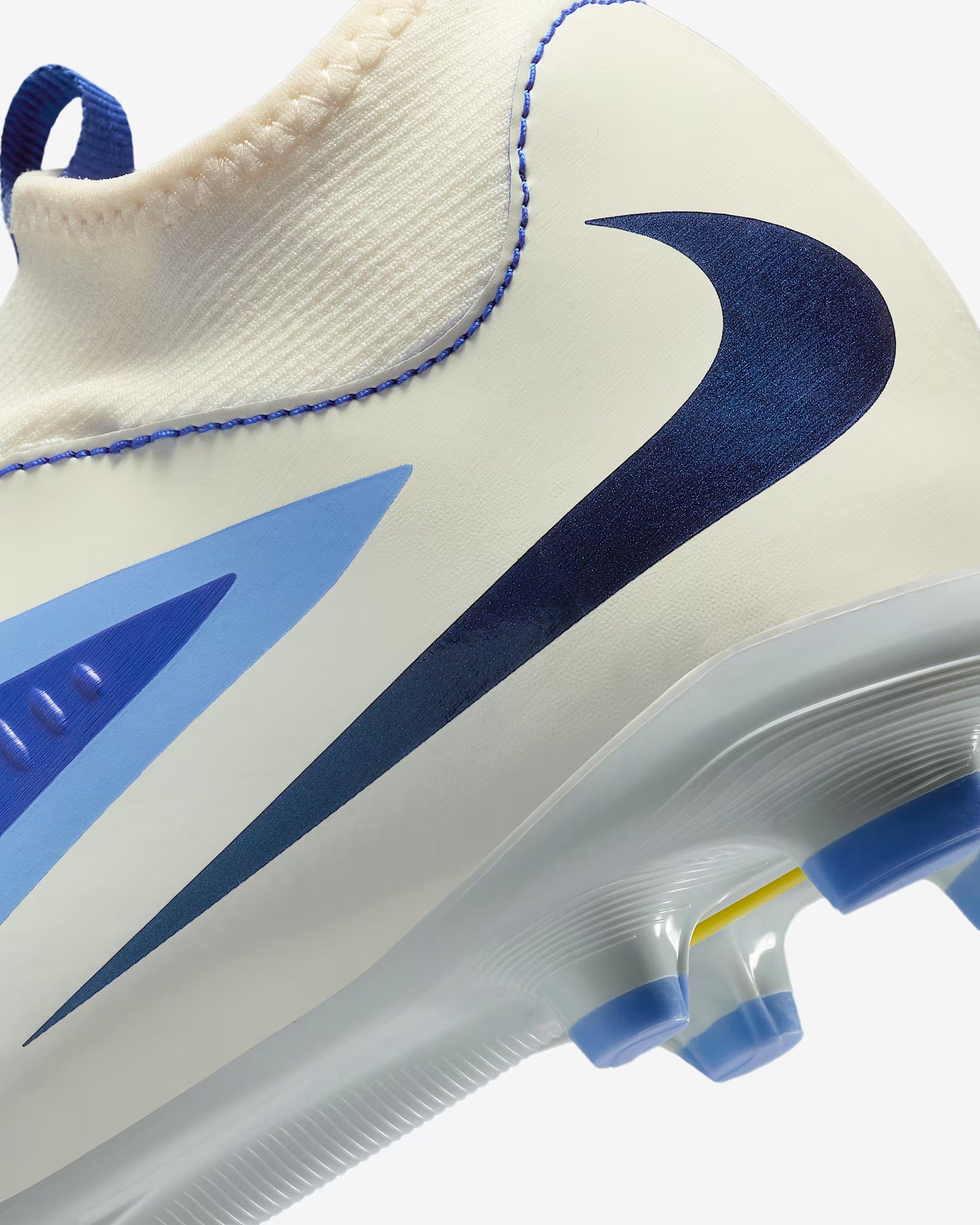 Close-up of a soccer cleat with blue and white design on a white background