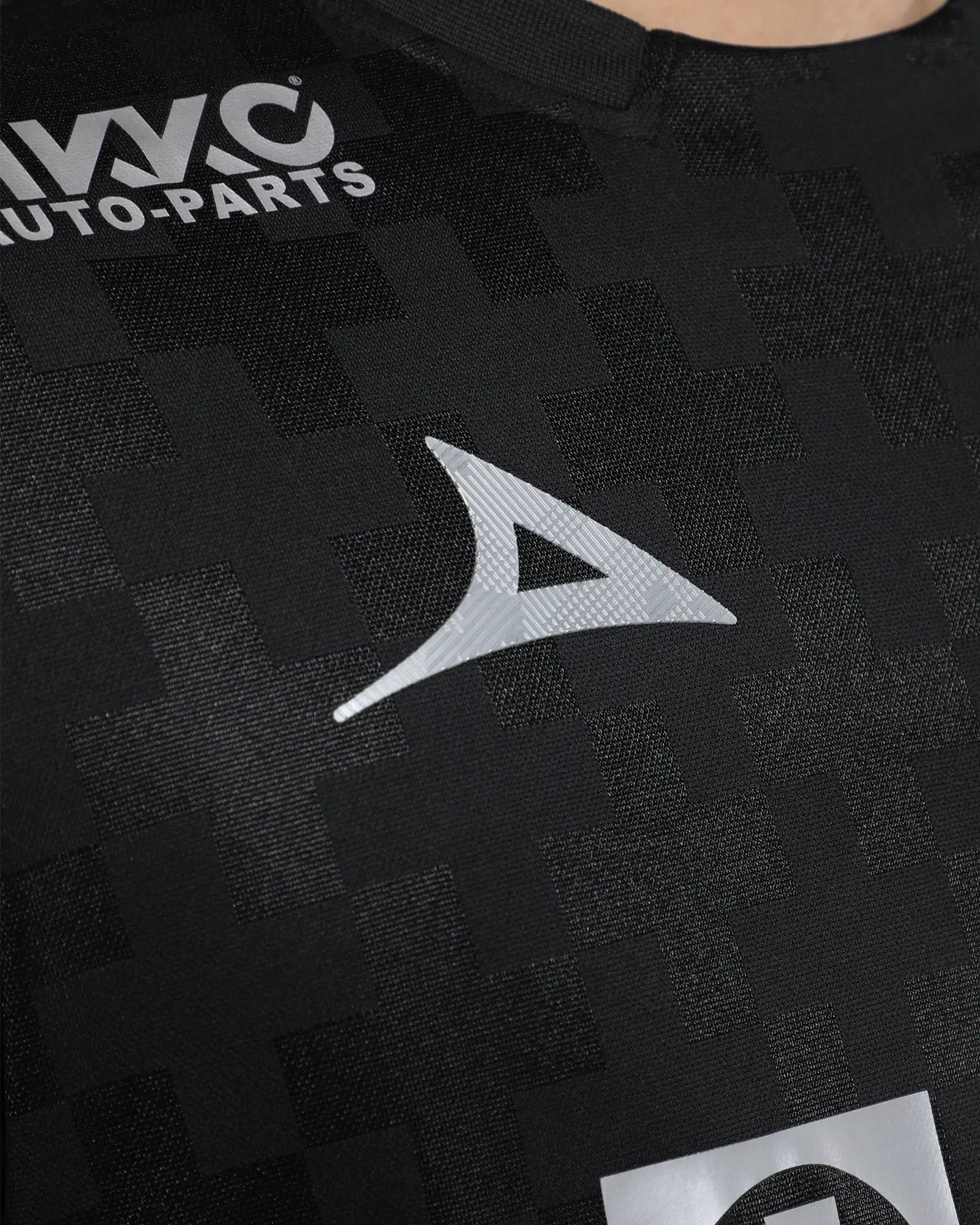 Black shirt with a logo and text on a dark background