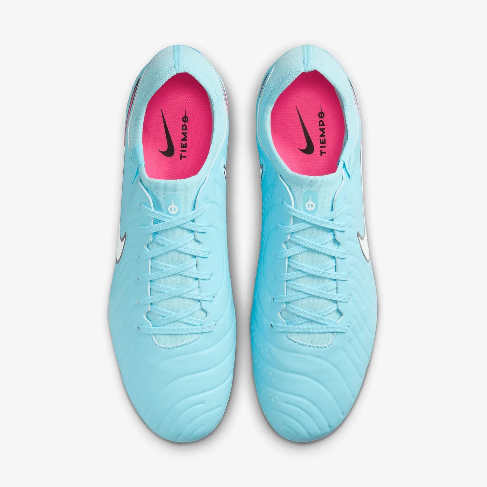 Pair of light blue soccer cleats with pink lining on a white background