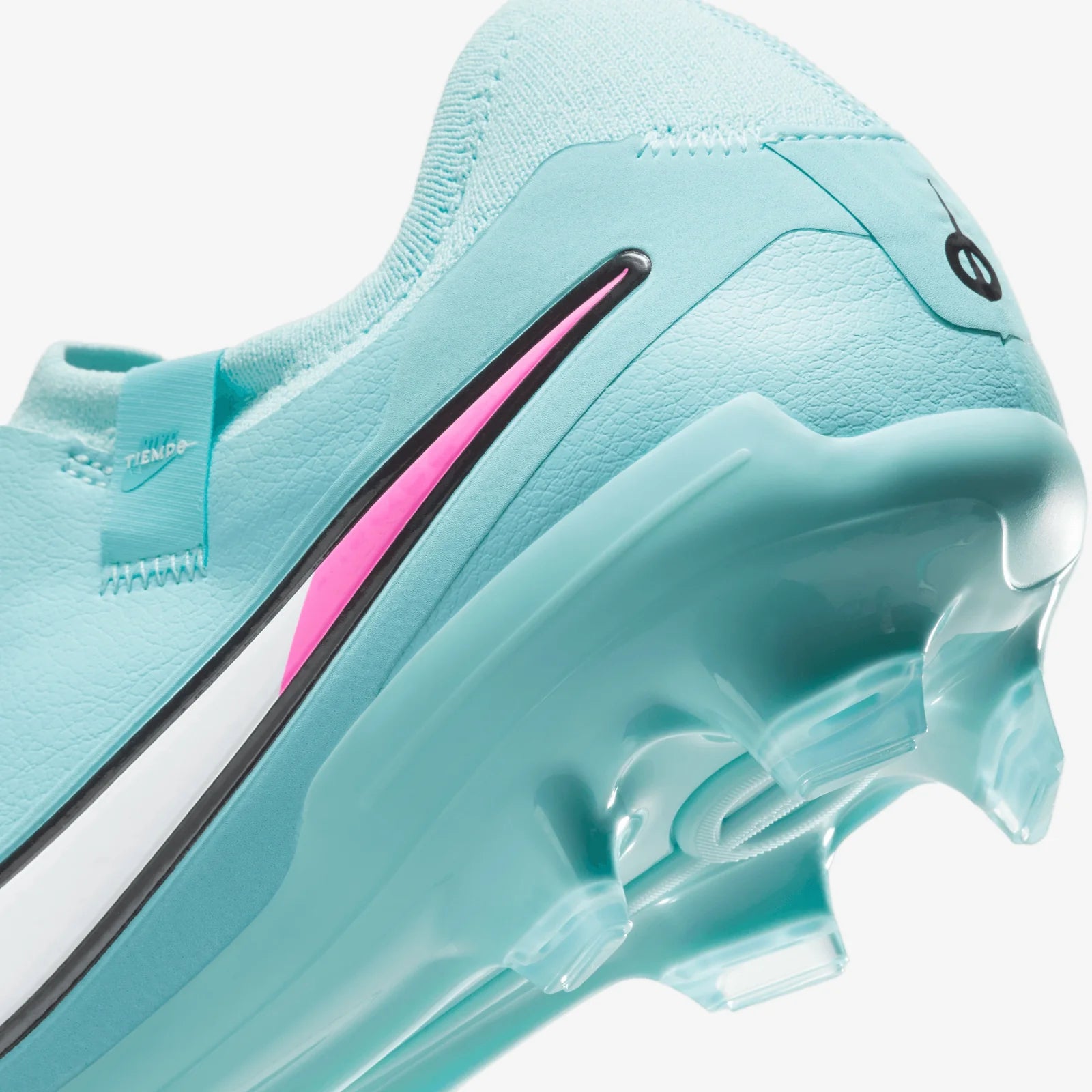 Close-up of a light blue athletic shoe with pink accents on a white background