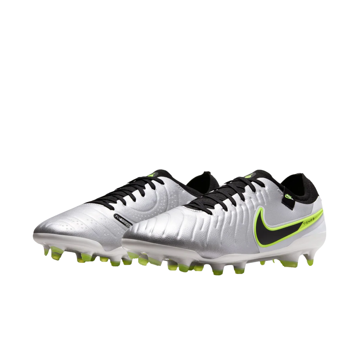Pair of silver soccer cleats with black and green accents on a white background