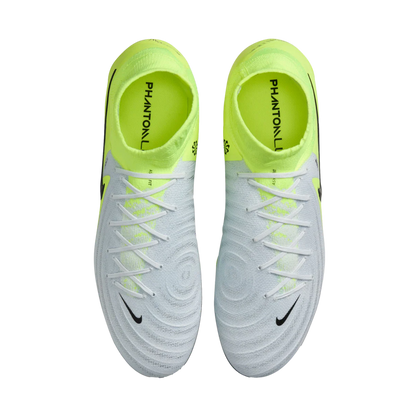 Pair of white soccer cleats with neon green accents on a white background