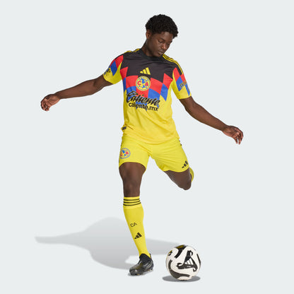 Person wearing a colorful soccer jersey and shorts with a ball on a white background