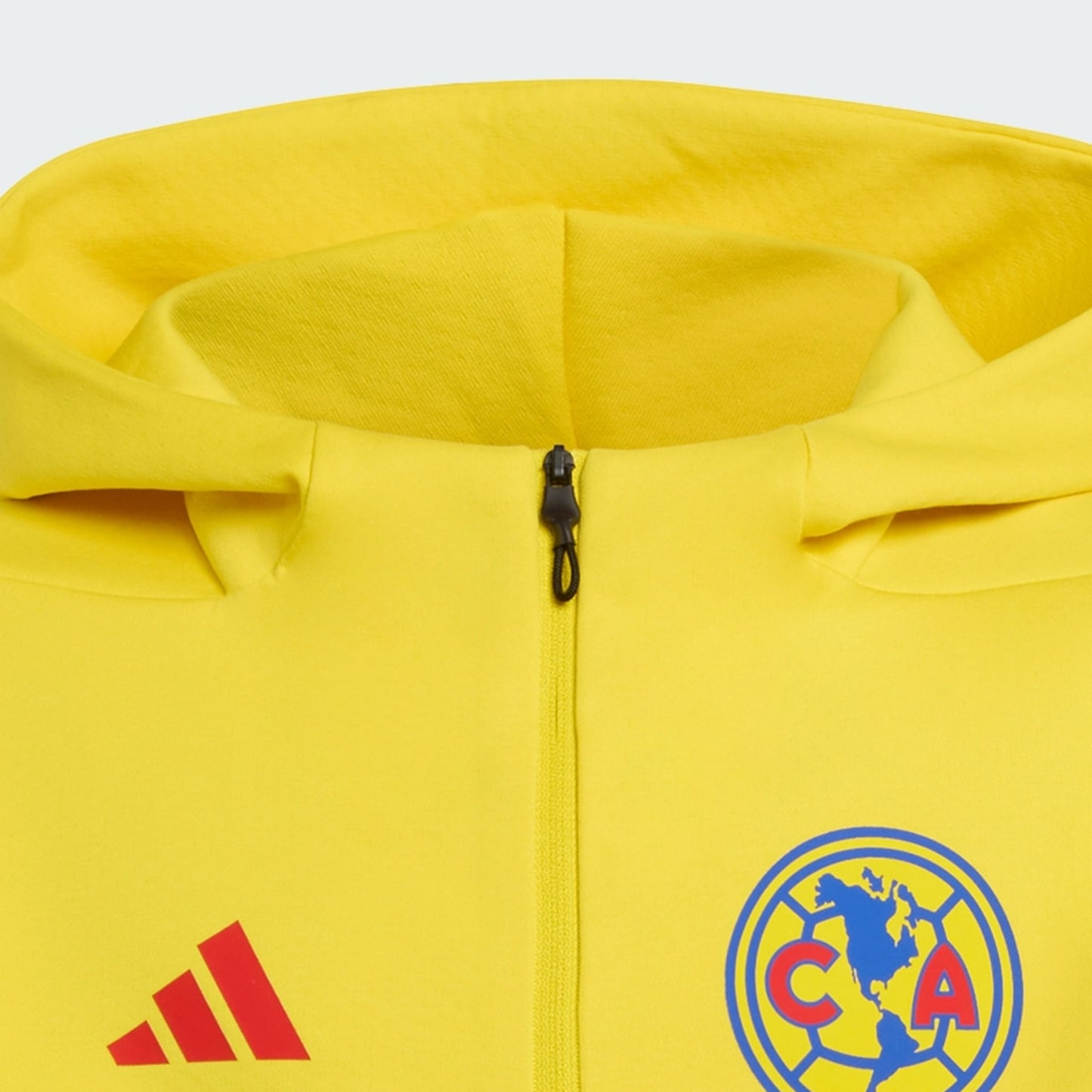 Yellow jacket with Adidas logo and Club América emblem on a light gray background