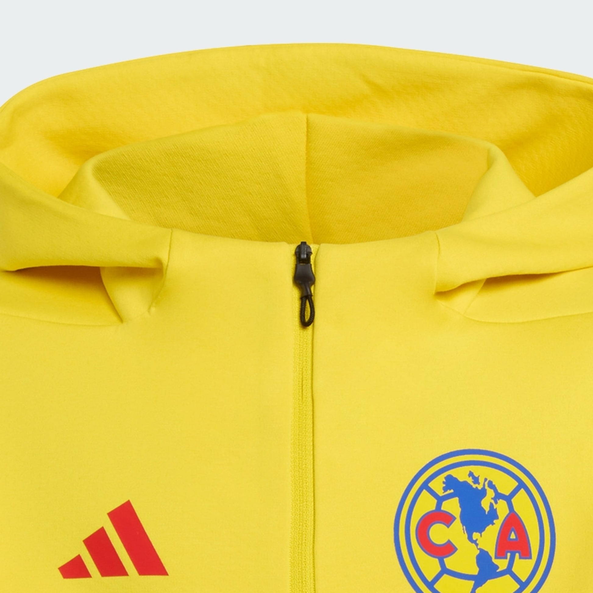 Yellow jacket with Adidas logo and Club América emblem on a light gray background