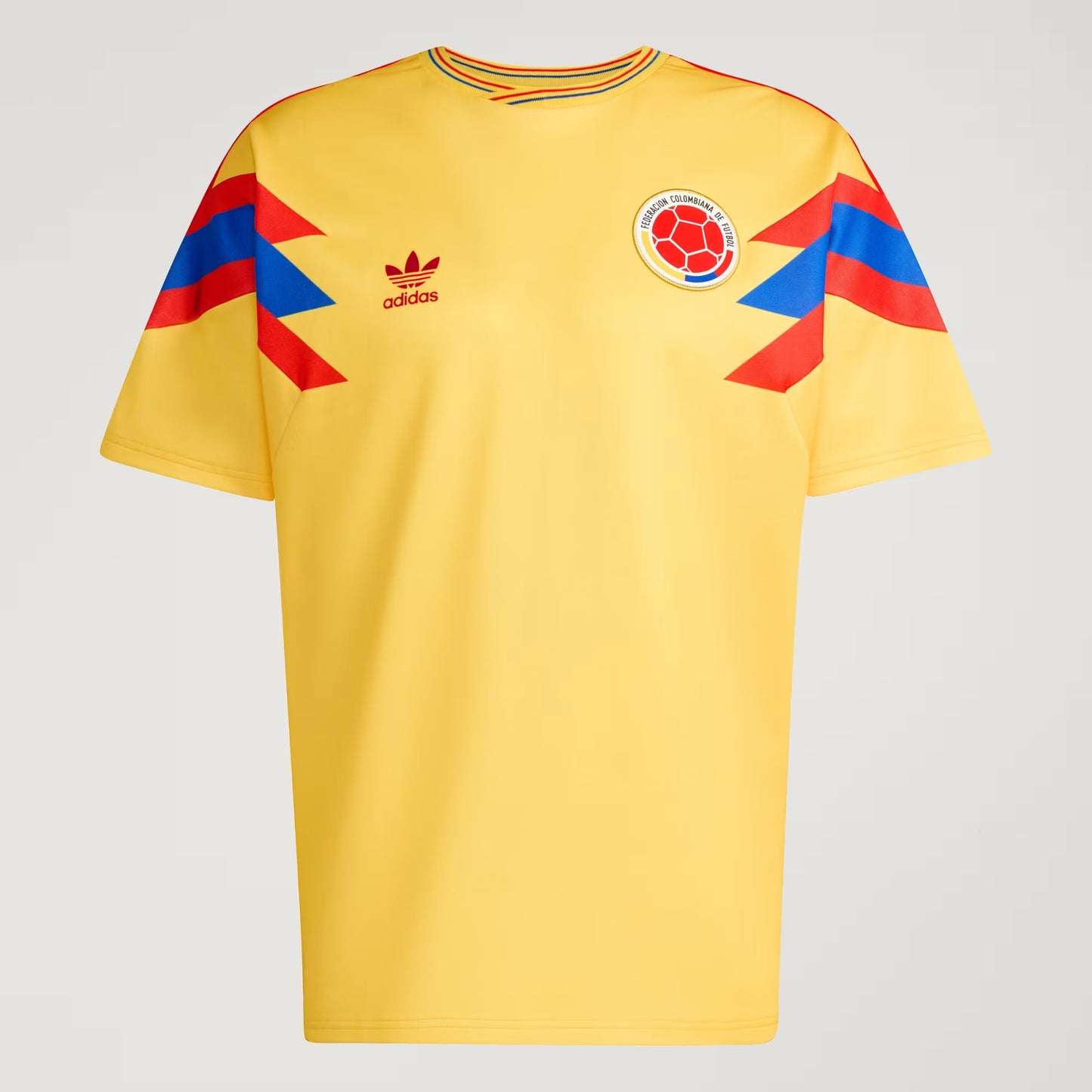 Yellow sports jersey with Adidas logo and Colombian flag design on a gray background