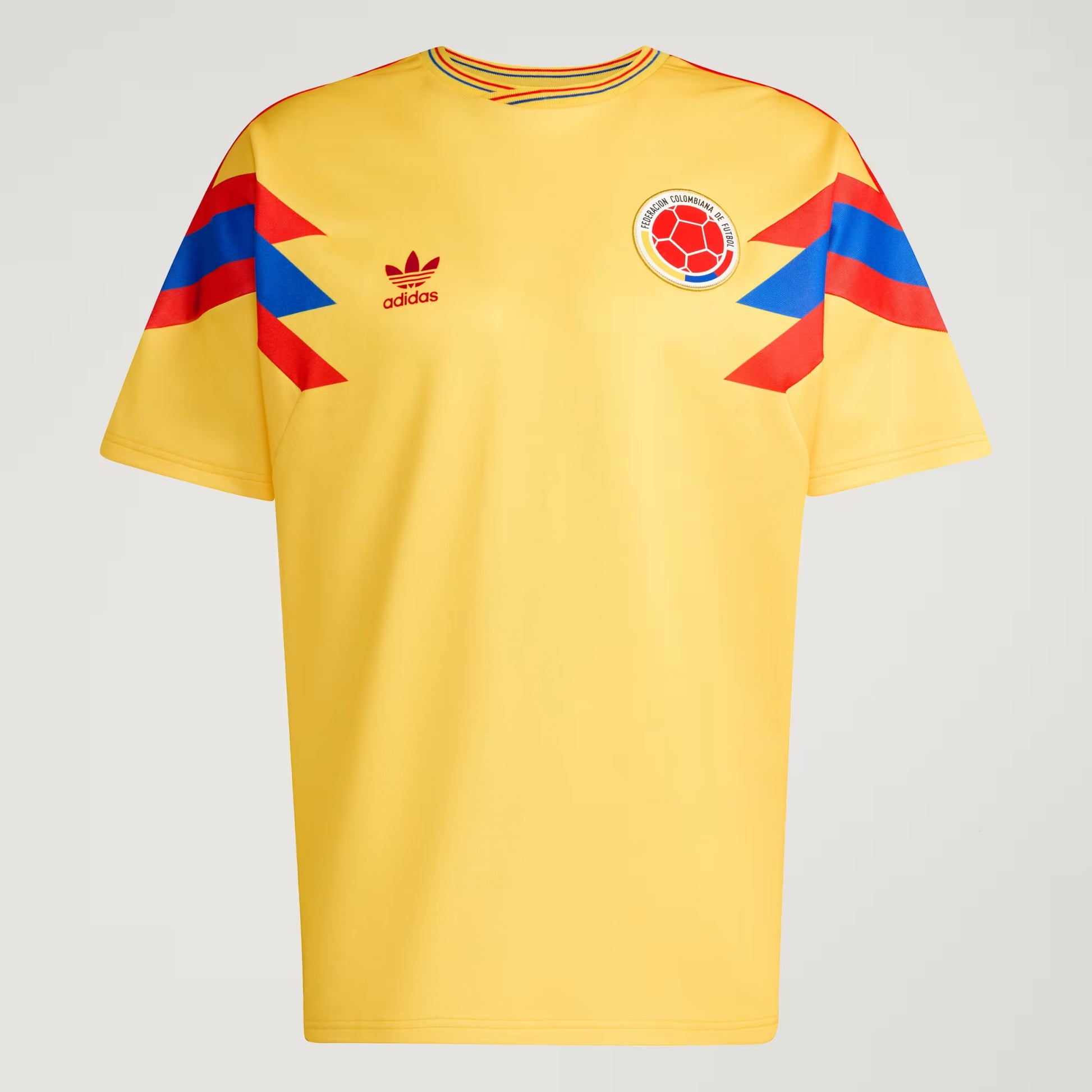 Yellow sports jersey with Adidas logo and Colombian flag design on a gray background