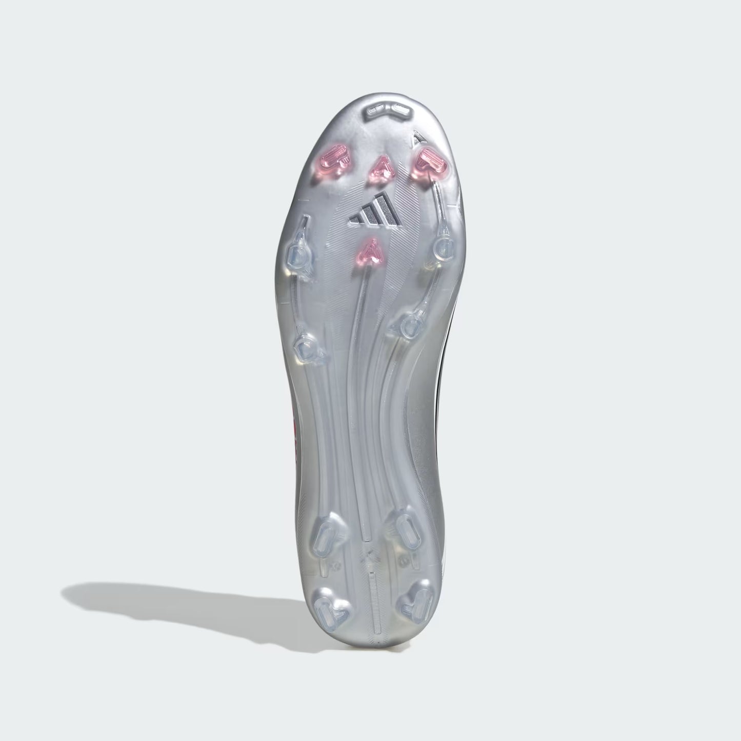 Clear soccer cleat sole with pink and blue studs on a light gray background