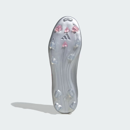 Clear soccer cleat sole with pink and blue studs on a light gray background