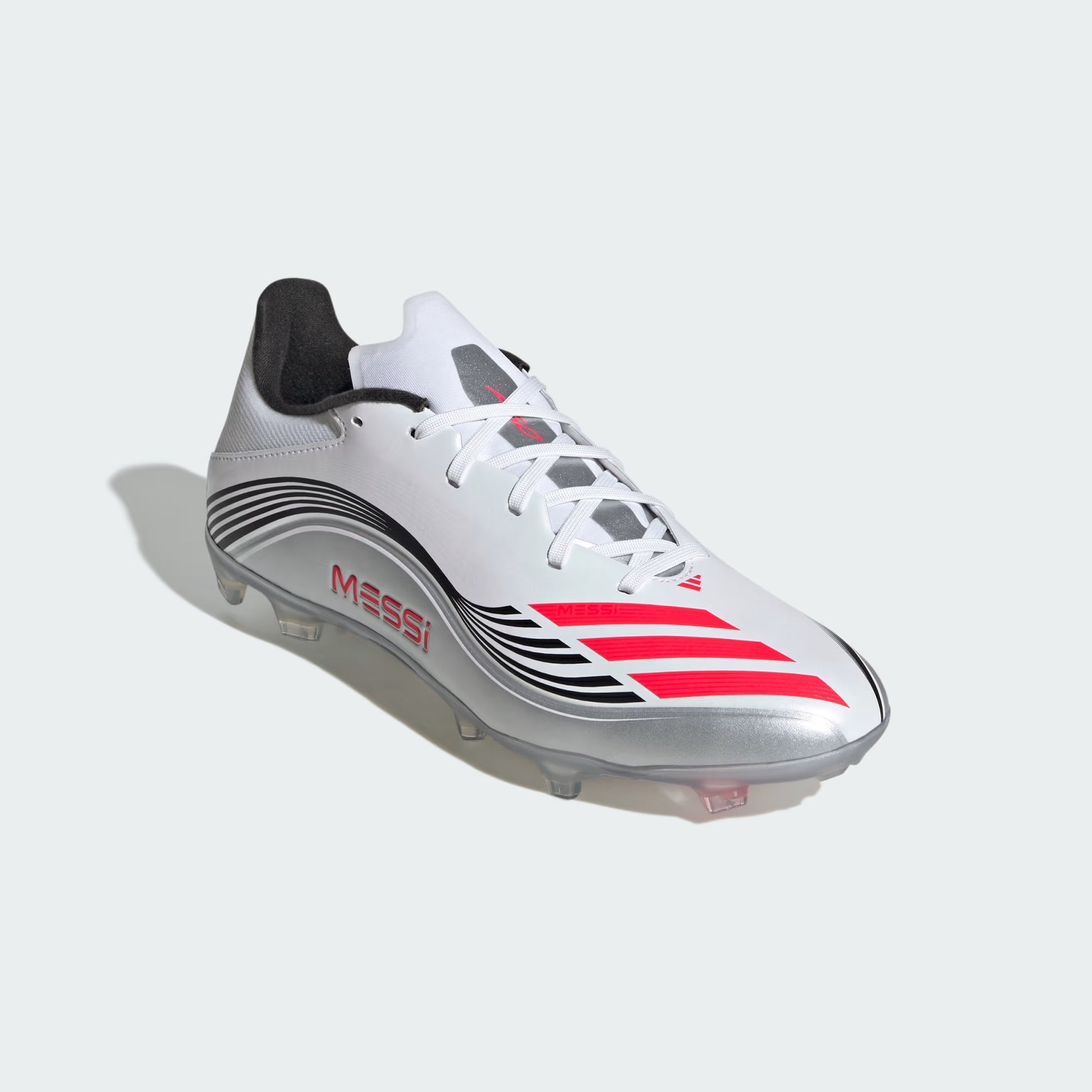 Soccer shoe with 'Messi' branding on a light gray background