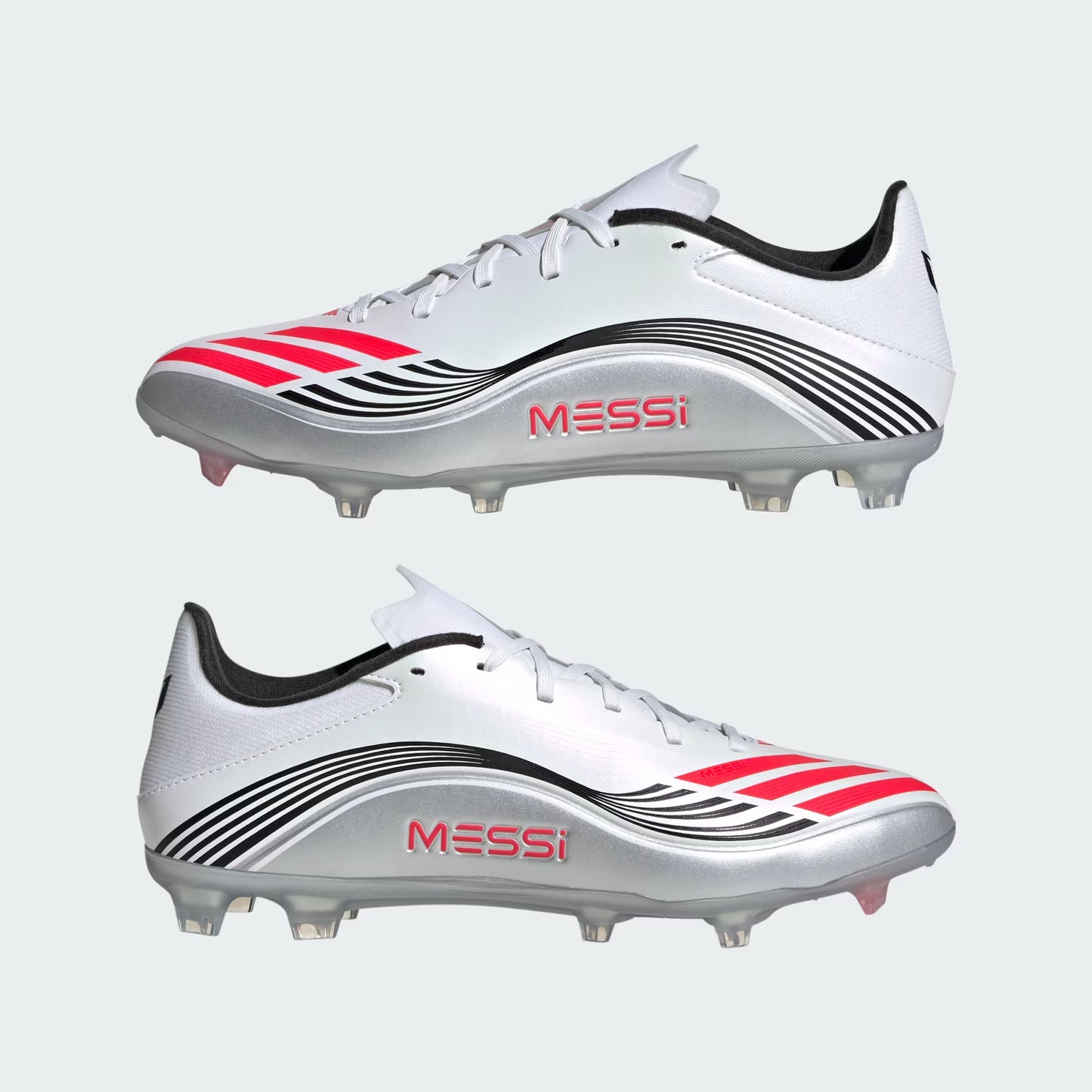 White soccer cleats with red and black accents and 'Messi' branding on a light gray background.