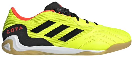 Bright yellow soccer shoe with black stripes and red text on a white background