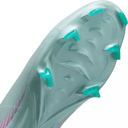 Close-up of a sports shoe sole with green accents on a white background