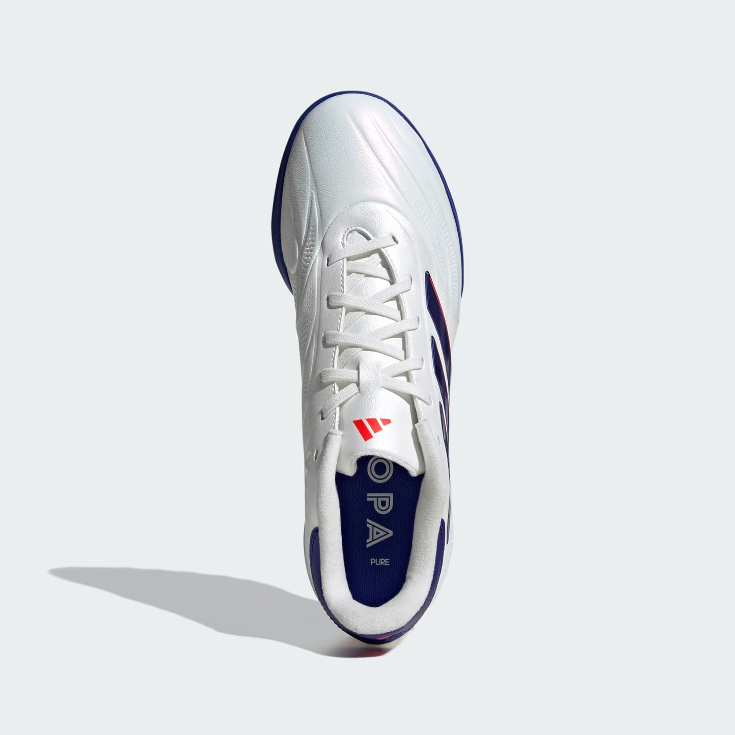 White and blue soccer cleat with brand logo on a light gray background