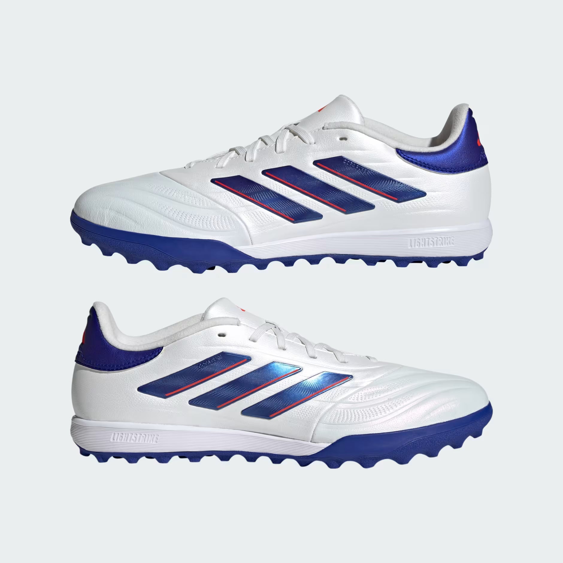 White and blue sports shoes with red accents on a light gray background