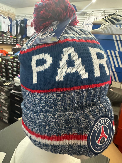 Knitted beanie with 'PARIS' and Paris Saint-Germain logo in a store setting