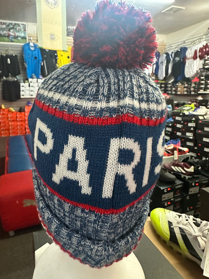 Knitted hat with 'PARIS' text in a store setting
