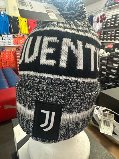 Black and gray knit beanie with 'Juventus' branding on a mannequin head in a store setting.