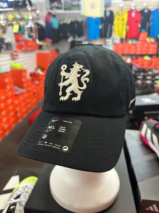 Black cap with a white logo on a mannequin head in a store setting