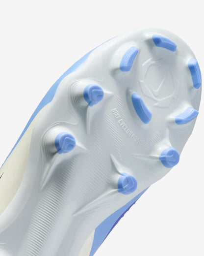 Close-up of a soccer cleat sole with blue studs on a white background