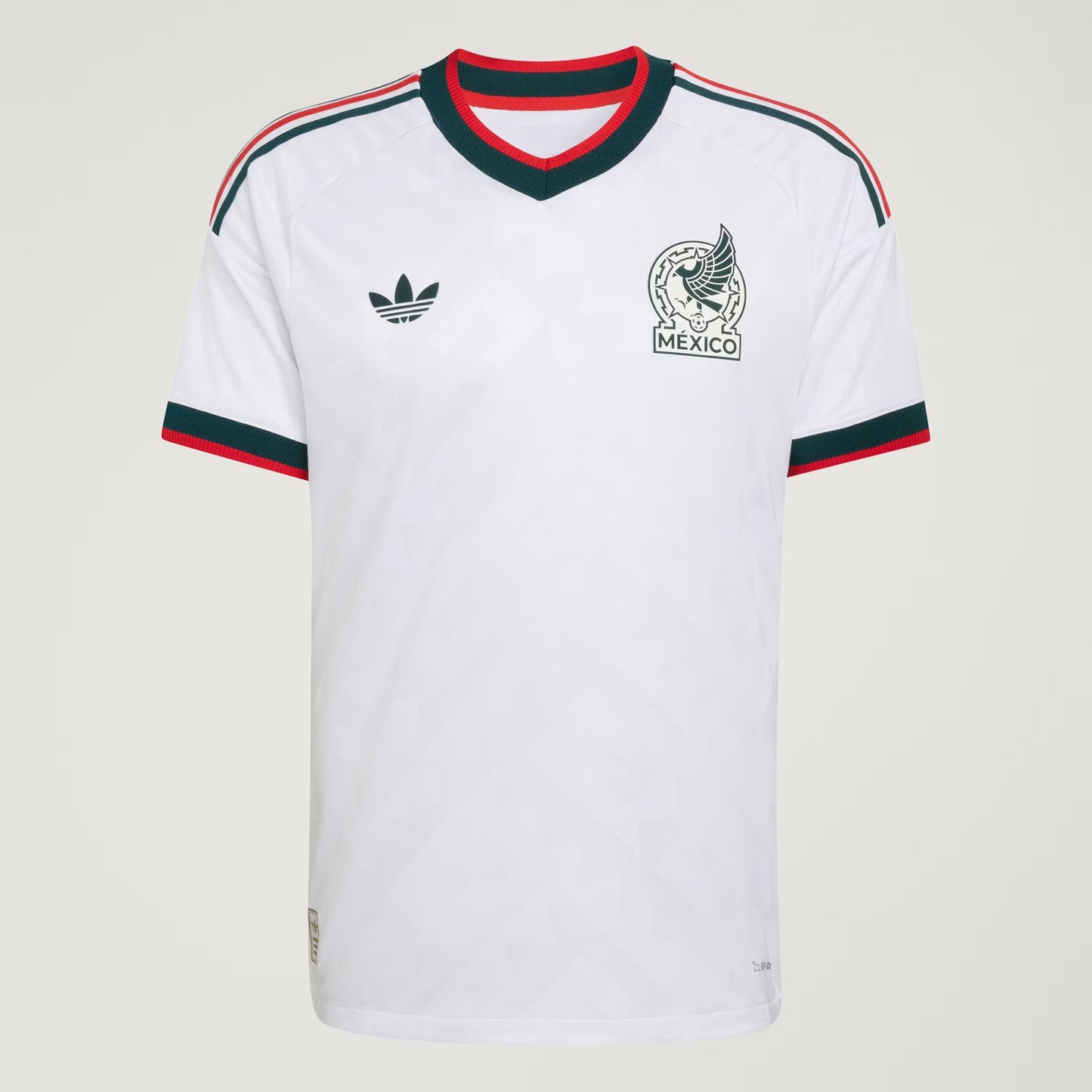 White sports jersey with Adidas logo and 'Mexico' emblem on a light gray background