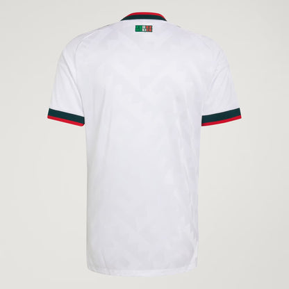 White shirt with green and red accents on a light gray background