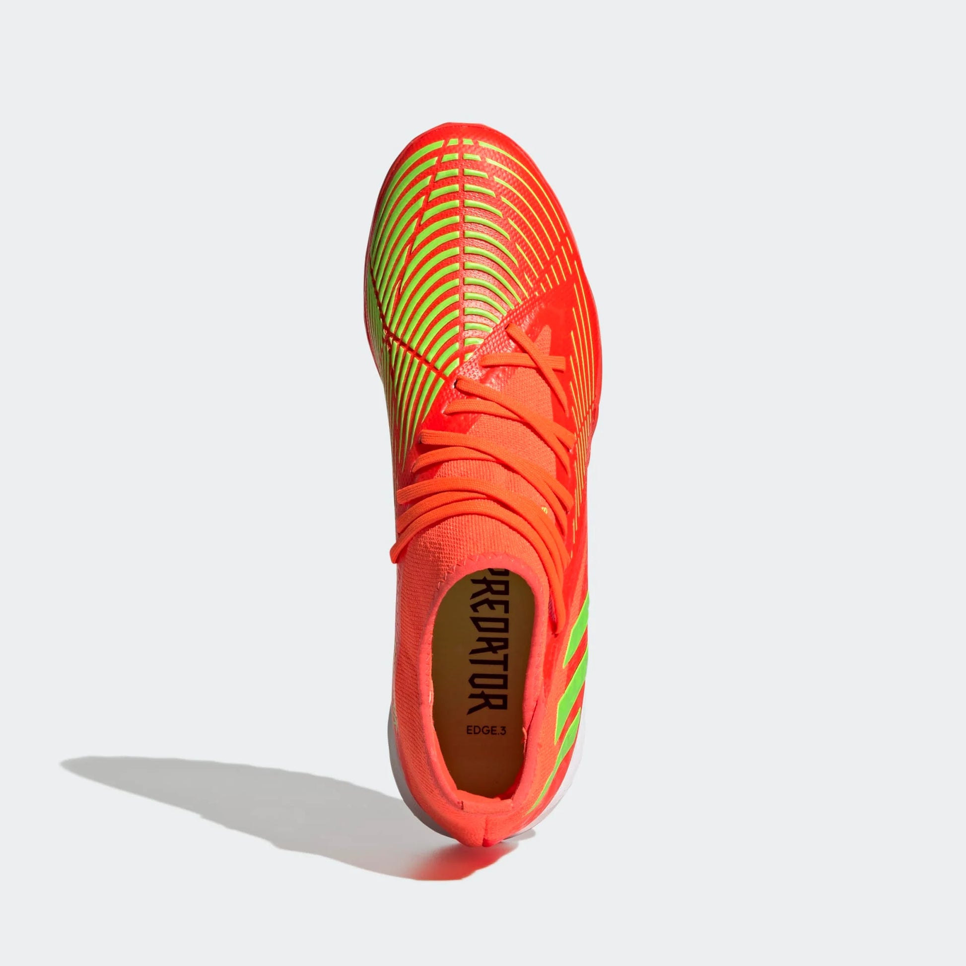Brightly colored soccer cleat on a light gray background