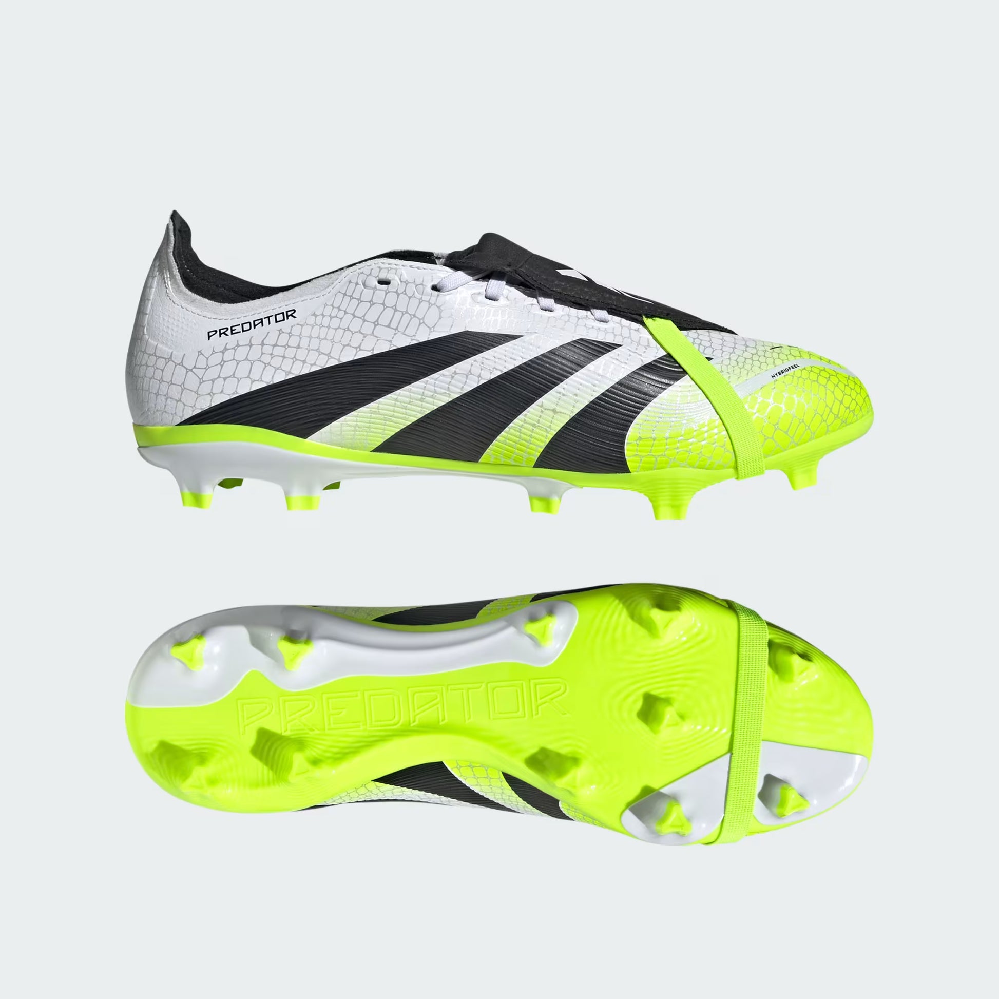 Pair of soccer cleats with white, black, and neon green design on a light gray background