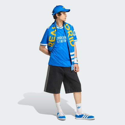 Person wearing a blue sports outfit with visible branding on a white background