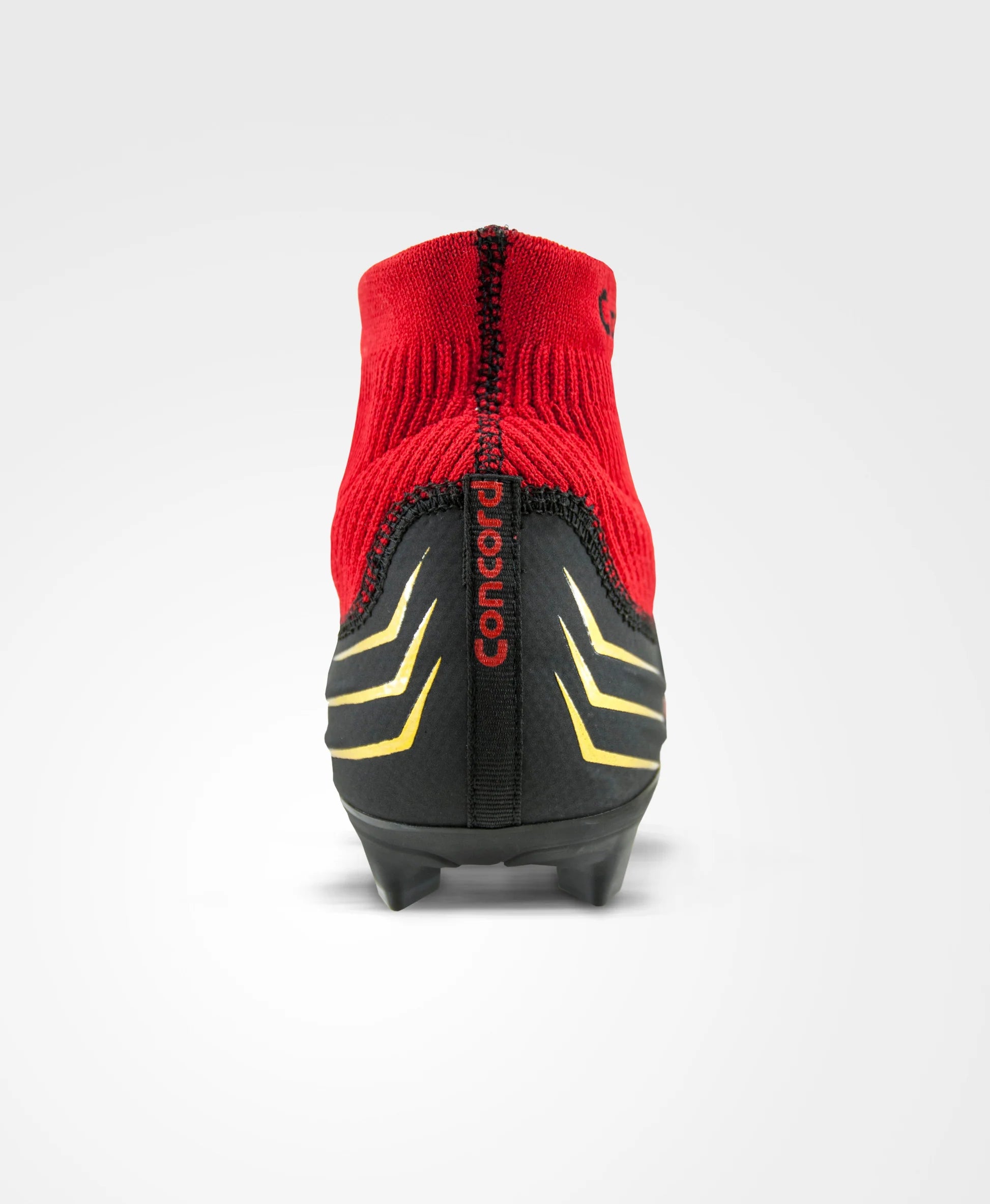 Red soccer cleat with black and yellow accents on a white background