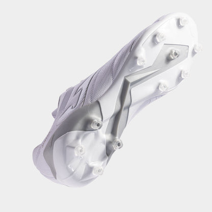 Close-up of a white athletic shoe with cleats on a light gray background