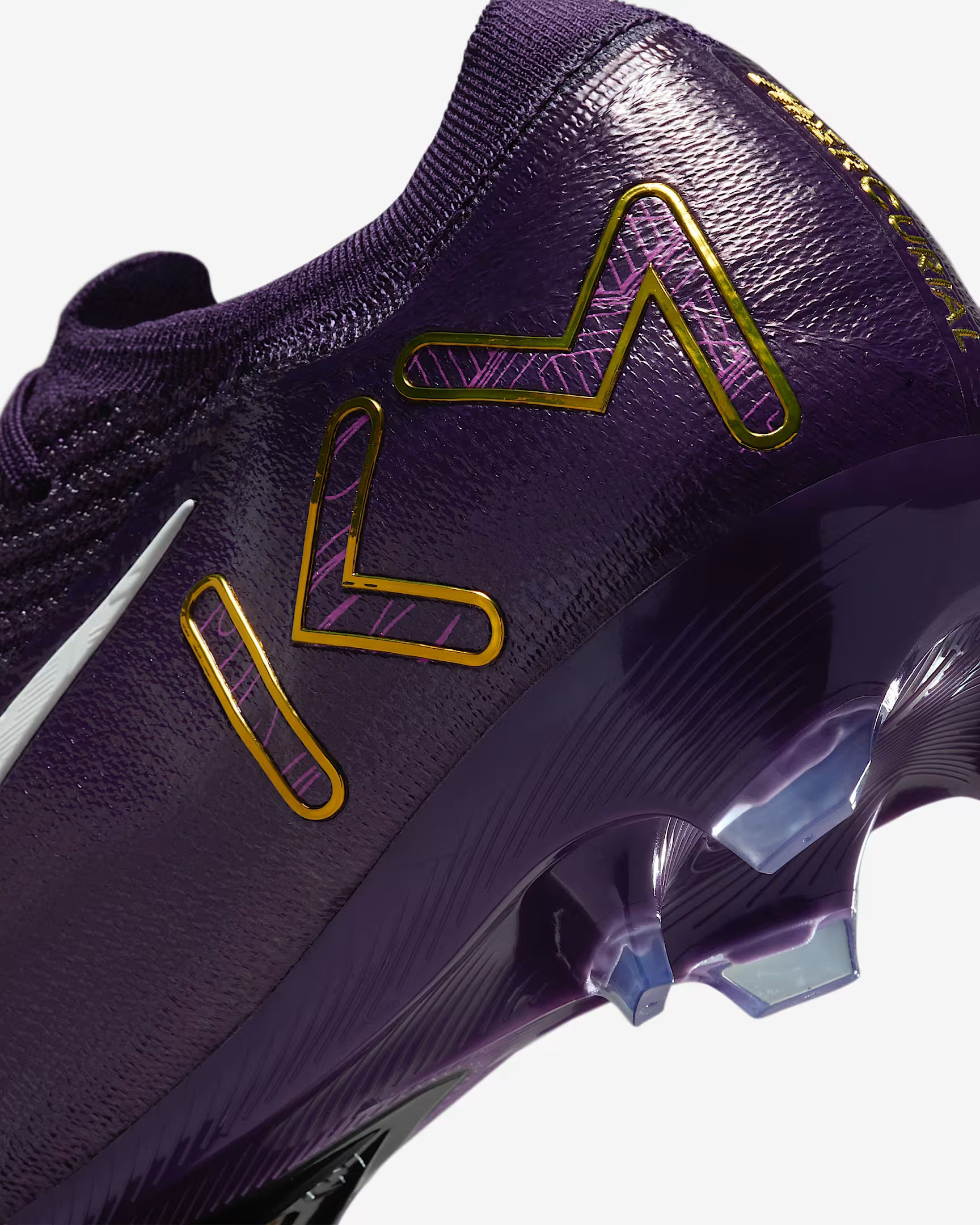 Purple sports shoe with gold and pink accents on a white background