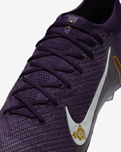 Purple sports shoe with a white logo on a light gray background