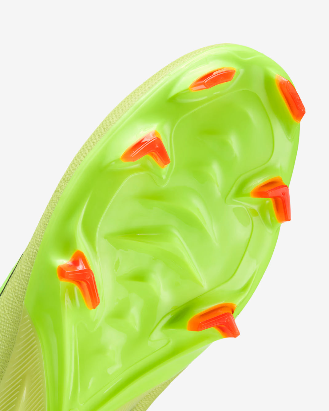 Close-up of a green sports cleat with orange studs on a white background