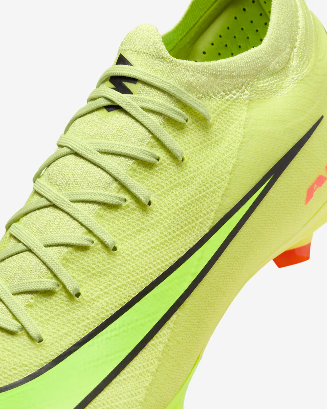 Bright green soccer cleat with black accents on a white background