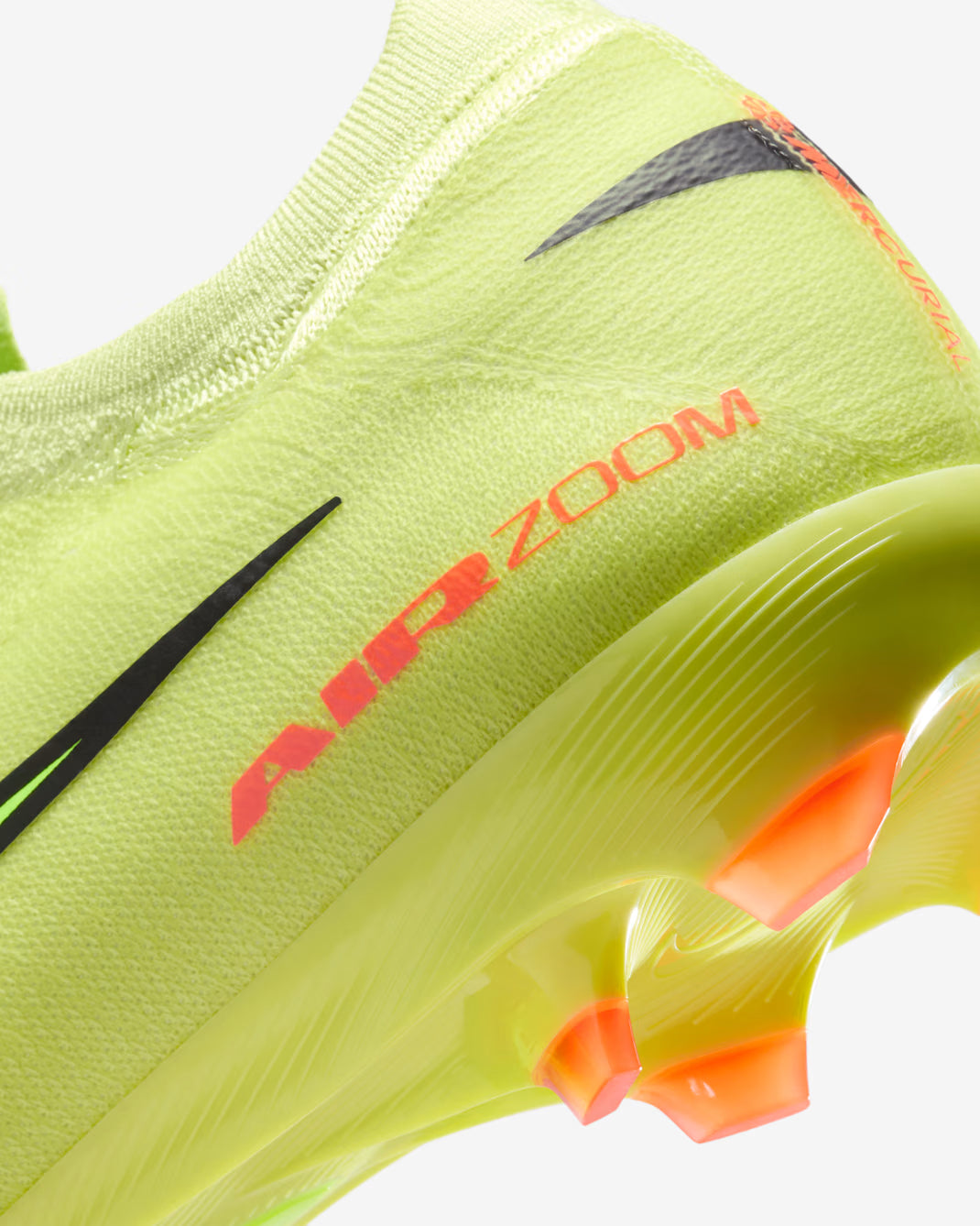 Close-up of a neon green athletic shoe with 'Air Zoom' text on a white background