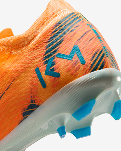 Close-up of an orange soccer cleat with blue accents on a white background