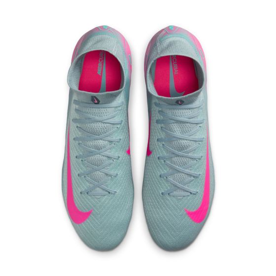 Pair of light blue and pink soccer cleats on a white background