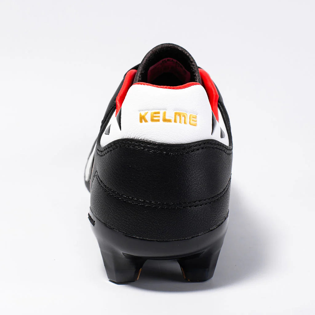 Kelme Black soccer cleat with red and white accents on a white background
